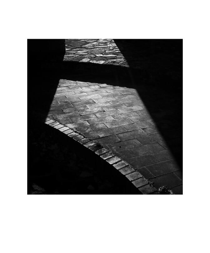 Black and white photograph by Bradley Cummings titled STONE FOOTPATH AND SHADOWS, University Ave., Canberra, 2024.