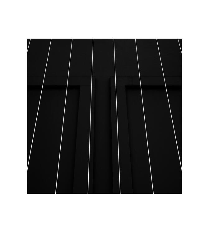 Black and white photograph by Bradley Cummings titled STEEL CABLES AND WALL, Goulburn, 2024.