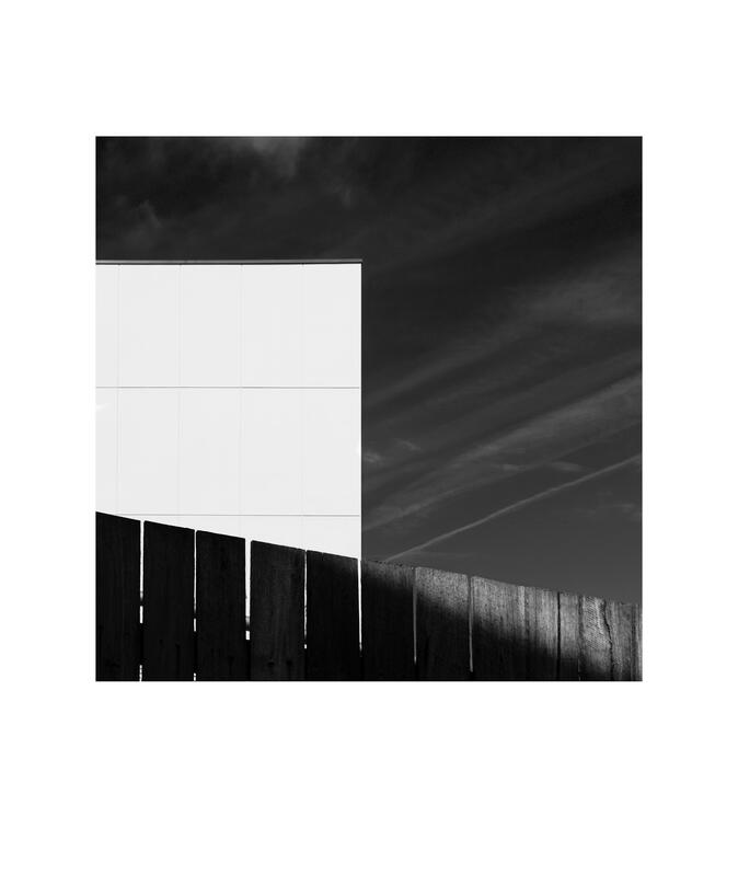Black and white photograph by Bradley Cummings titled BACK FENCE, Canberra, 2021