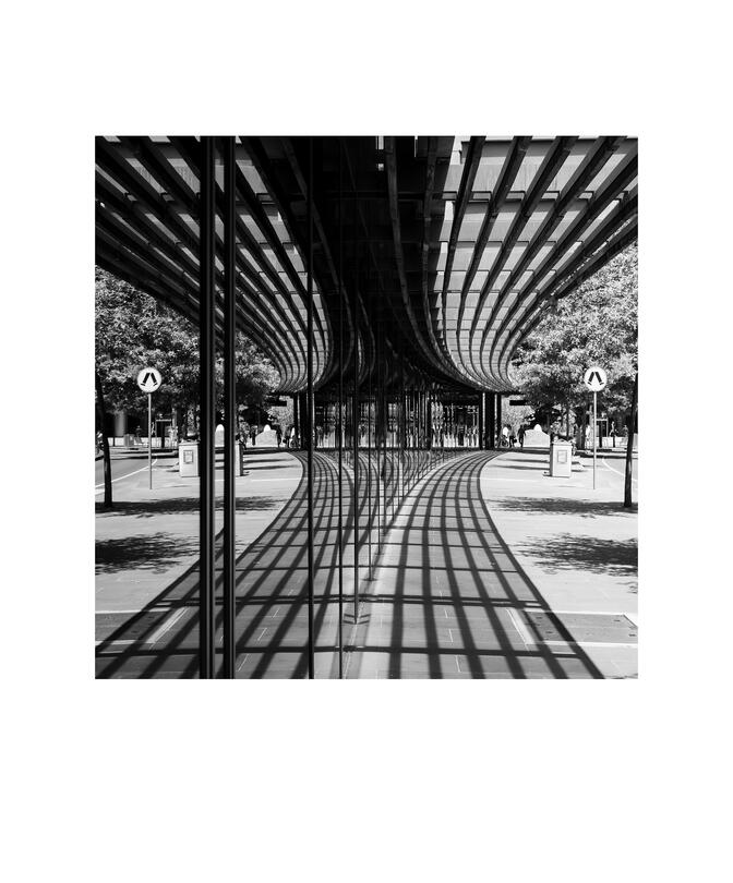 Black and white photograph by Bradley Cummings titled FOOTPATH AND BUILDING, Collins Street, Docklands, 2024