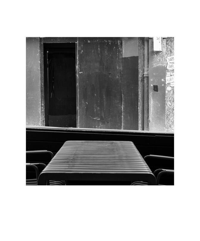 Black and white photograph by Bradley Cummings titled FOOTPATH CAFÉ VIEW, Little Bourke Street, Melbourne, 2024.